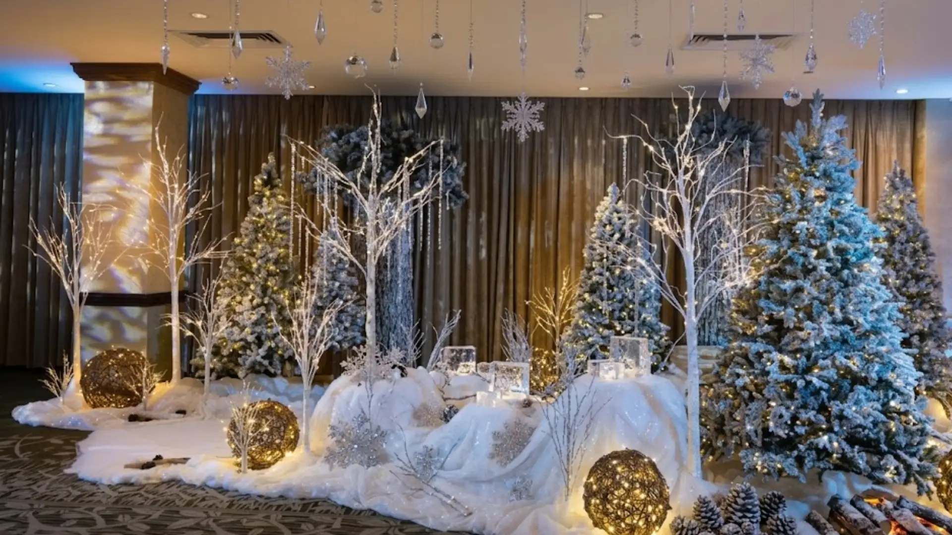 Winter themed indoor decor with snowy trees lights ornaments and festive holiday display in event space