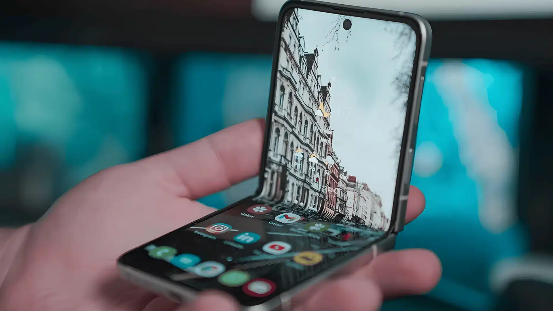 Foldable smartphone held in hand displaying modern interface highlighting flexible design and innovation