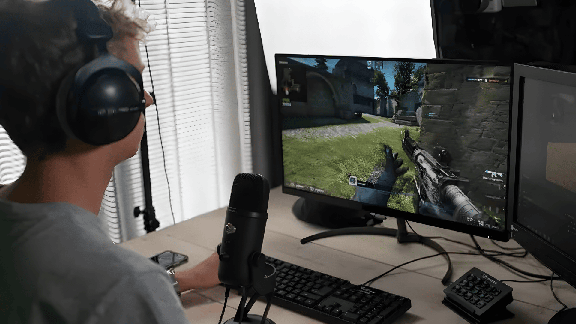 A gamer using a microphone and headset to play a shooter game, highlighting the effect of mic monitoring