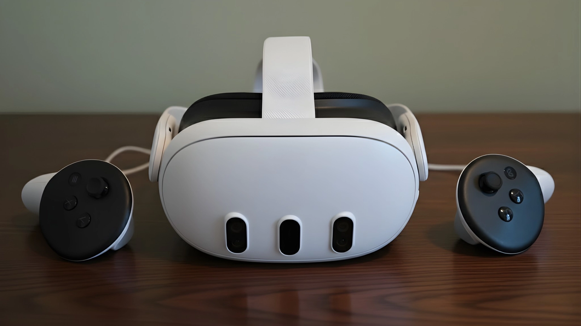 Meta Quest 3 headset with Touch Plus controllers placed on a wooden table, front view showing cameras and design details