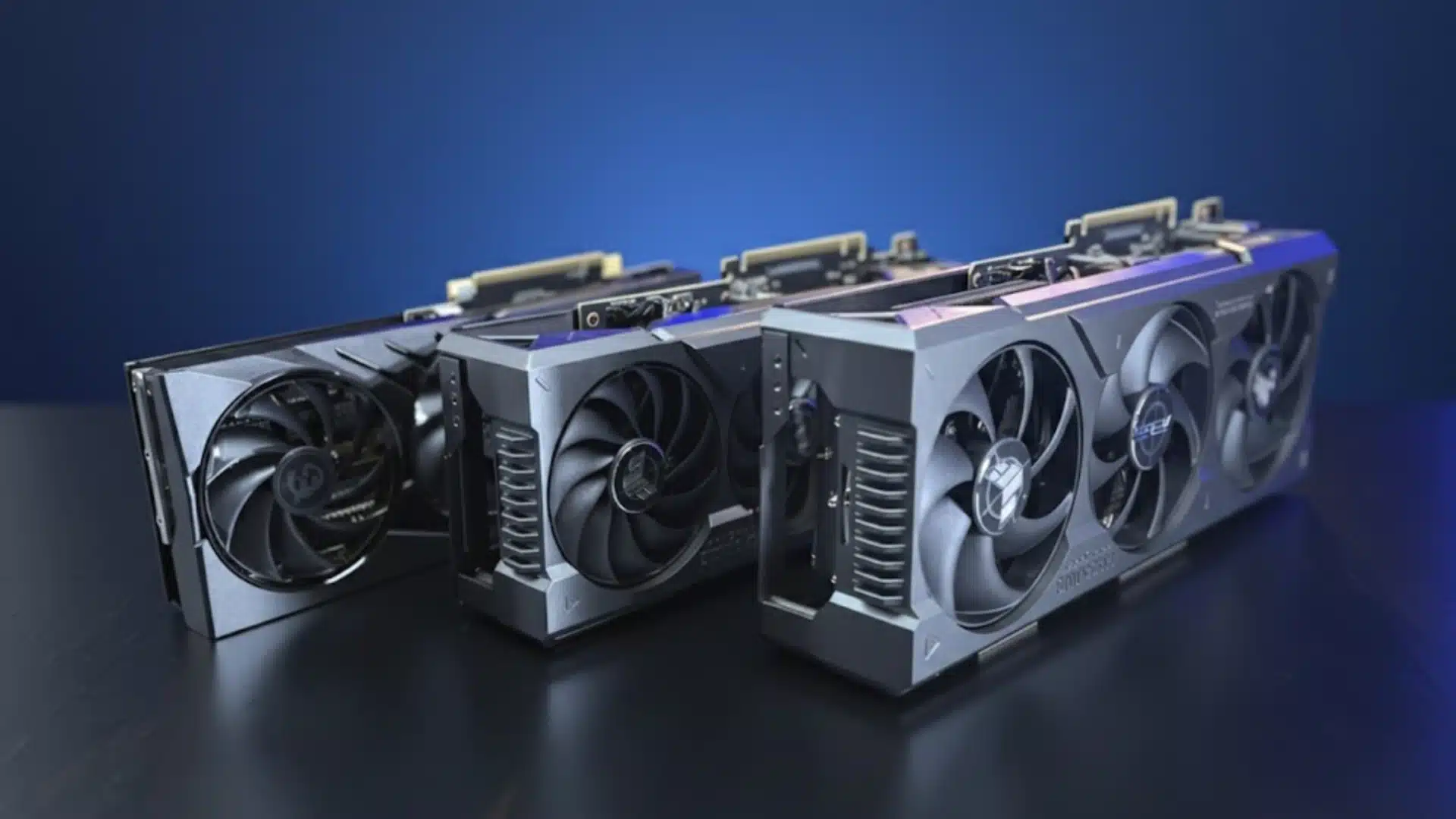 Multiple graphics cards lined up showing cooling fans and design differences against blue background