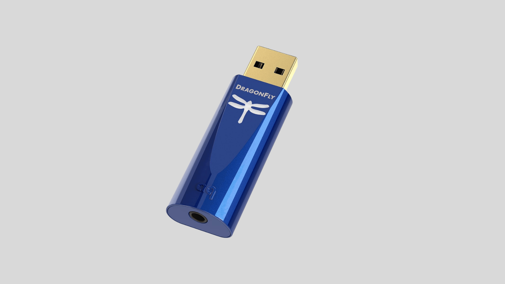 AudioQuest DragonFly Cobalt USB DAC with blue metal body, removable cap, gold USB connector, and headphone output on a clean background