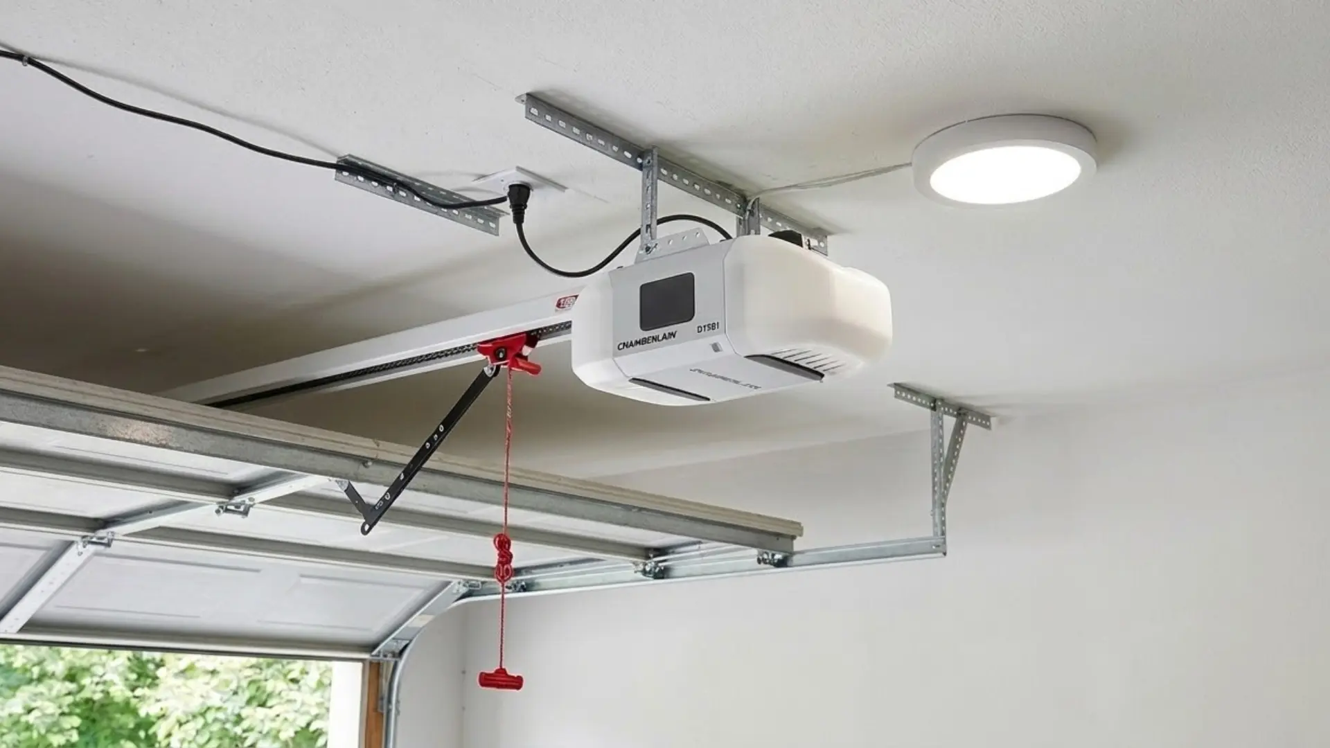 Ceiling mounted garage door opener motor connected to overhead garage door track inside residential garage system
