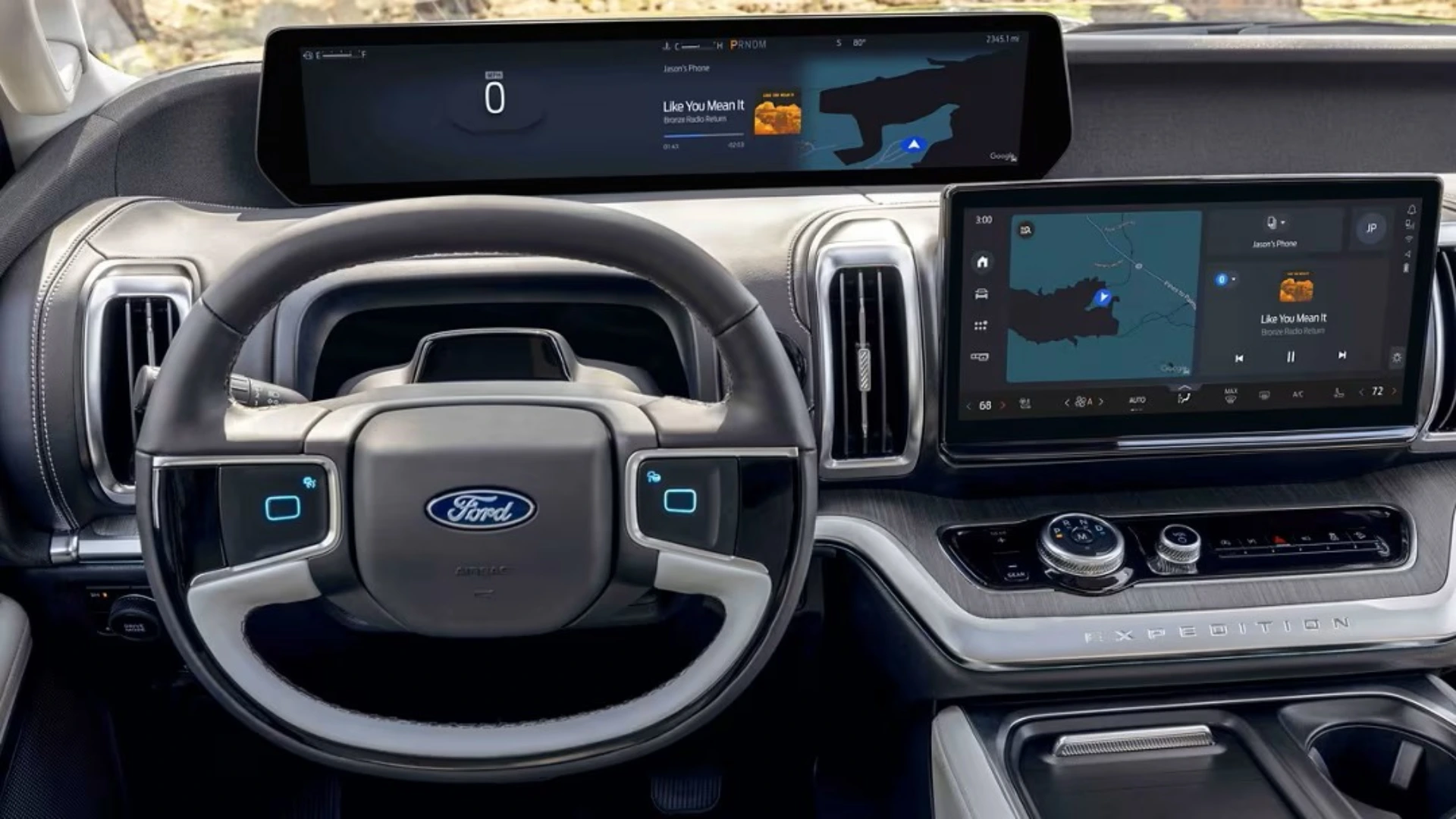 Ford SUV interior with steering wheel and large dual digital displays across dashboard and center console
