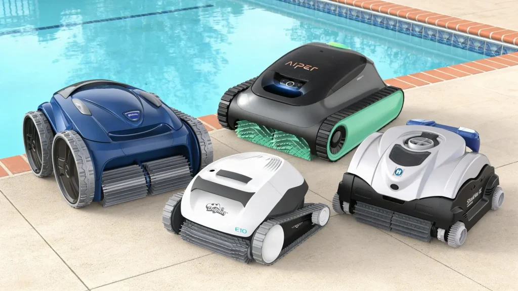 Four robotic pool cleaners placed beside a backyard swimming pool, showing different models for automated pool cleaning