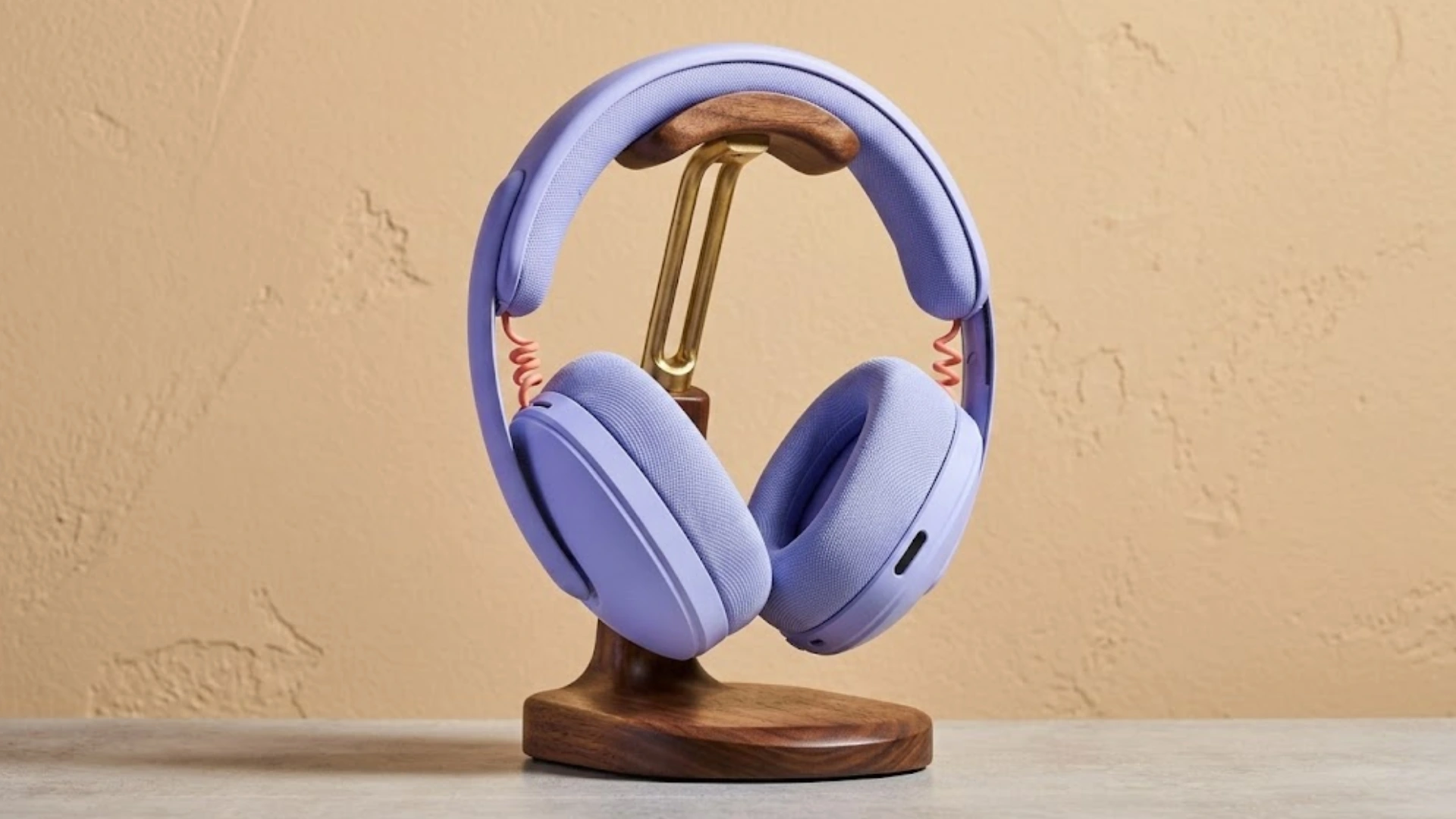 Logitech G325 Lightspeed gaming headset on wooden stand with cushioned earcups and padded headband against neutral background