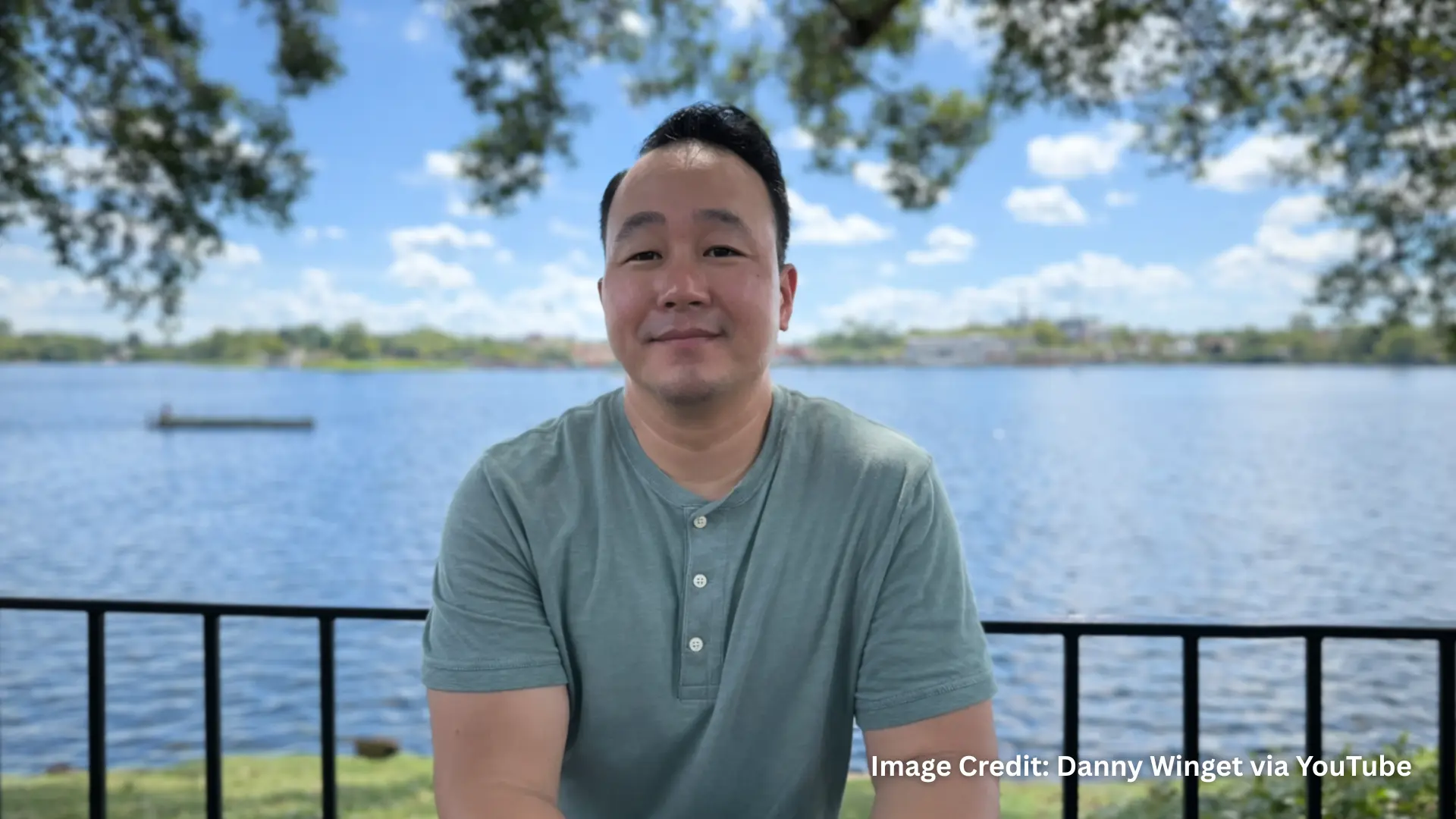 Man sitting by lakeside captured using Portrait mode on iPhone 16 Pro Max Camera showing natural depth effect