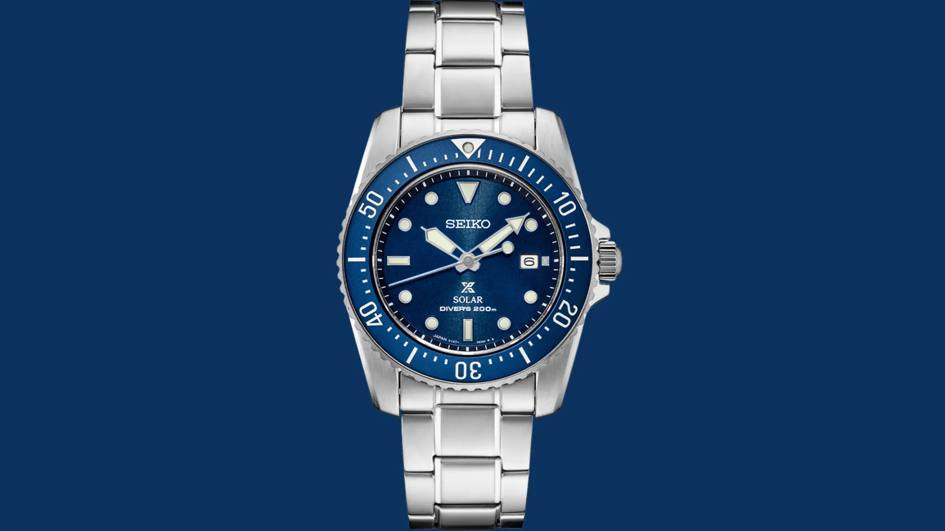 Seiko Prospex solar diver watch with blue dial and stainless steel bracelet displayed on a solid blue background