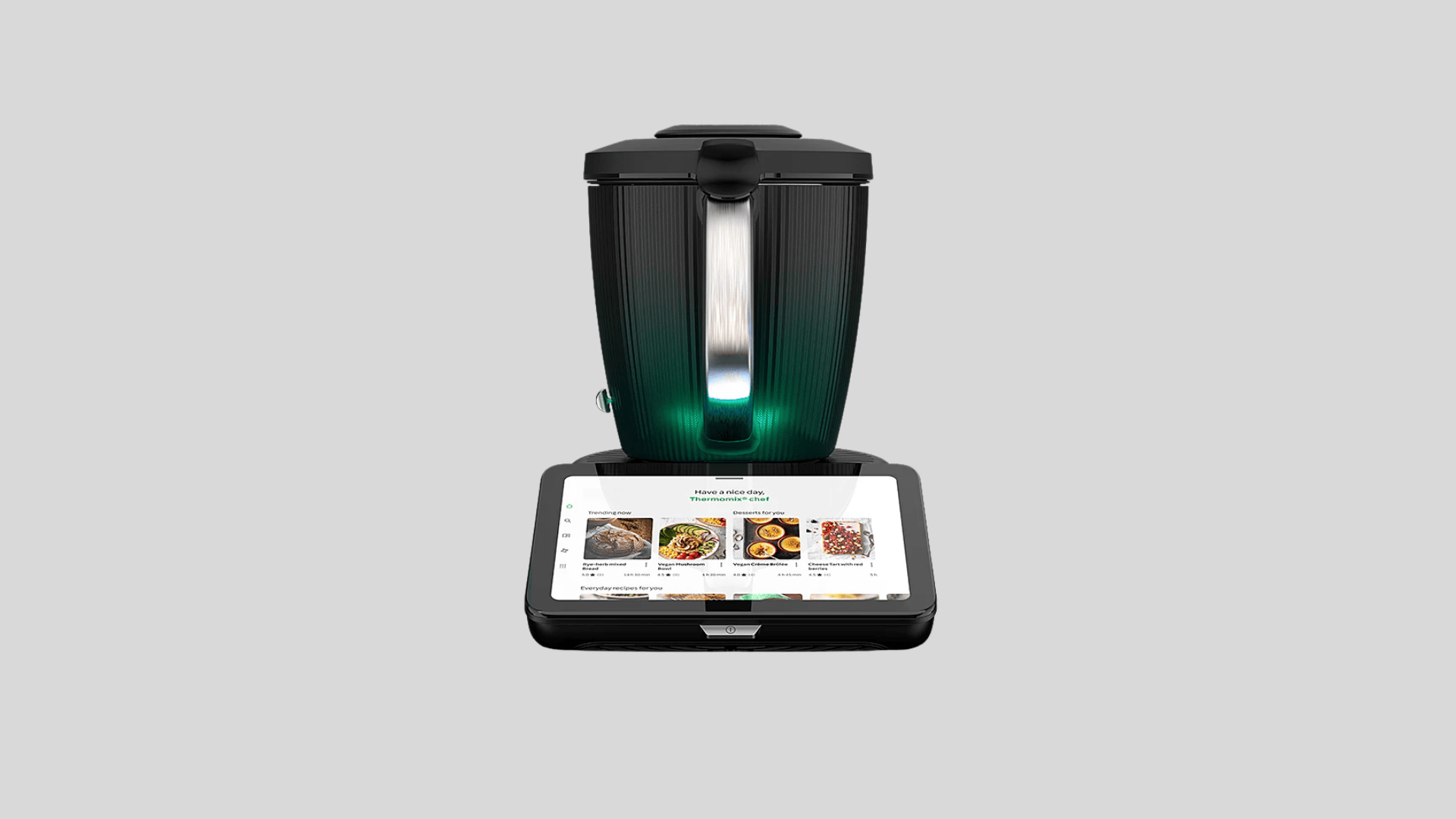 Thermomix smart kitchen robot with illuminated mixing bowl and touchscreen display showing guided recipes for automated cooking tasks