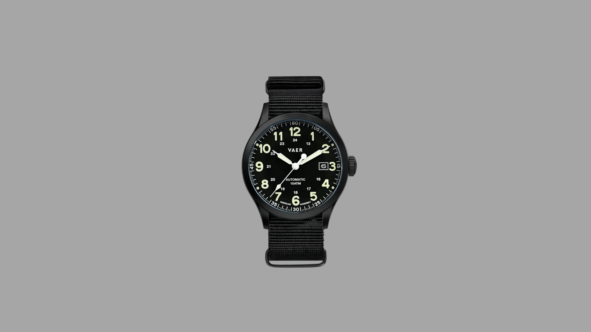 Vaer automatic field watch with black case, black dial, luminous Arabic numerals, date window, and black nylon strap