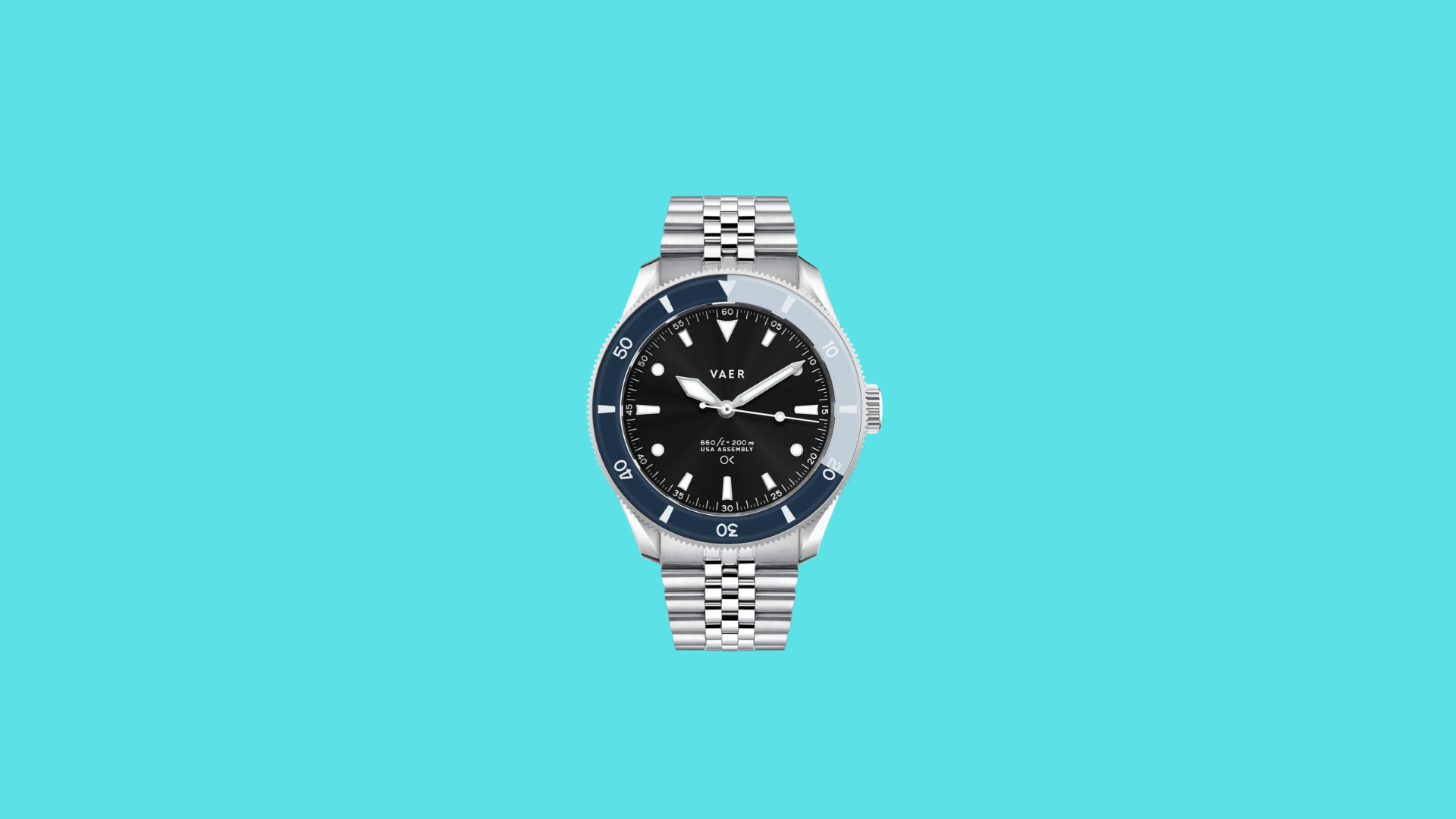 Vaer dive watch with black dial, blue rotating bezel, luminous markers, and stainless steel bracelet on plain background