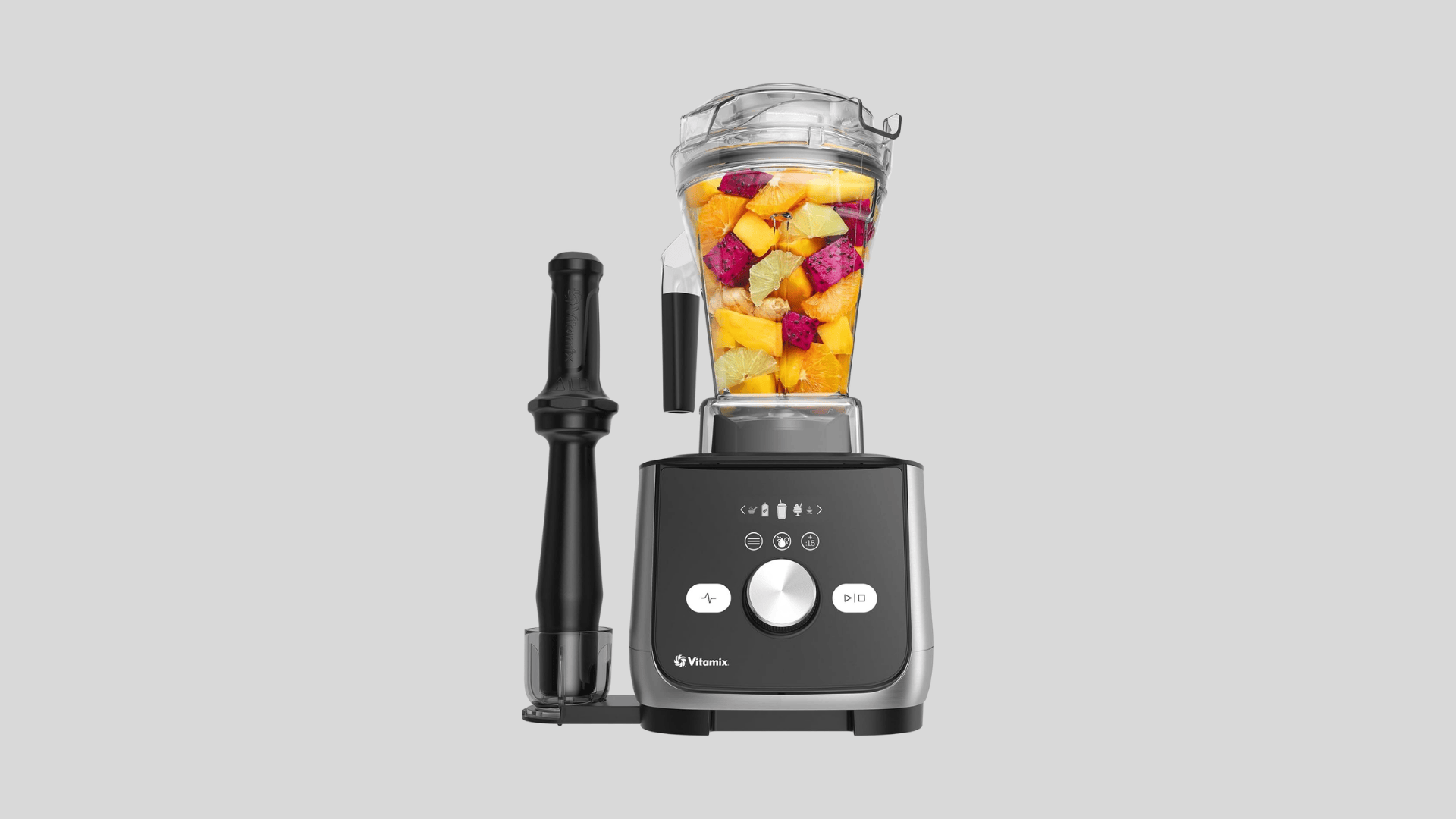 Vitamix blender with fruit filled jar, tamper, and touchscreen controls for smoothies and blended drinks