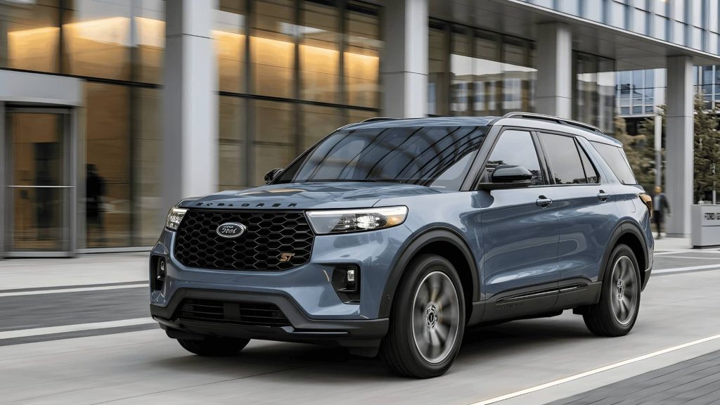 A grey Ford Explorer ST driving in front of a modern glass office building