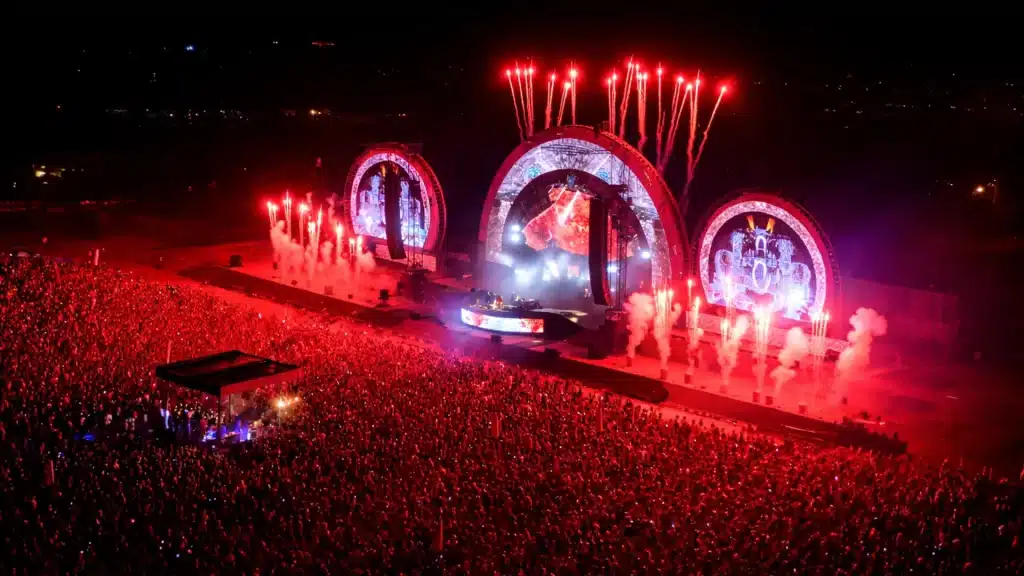 Massive stadium concert crowd with fireworks and stage during record breaking show with most tickets sold for a concert