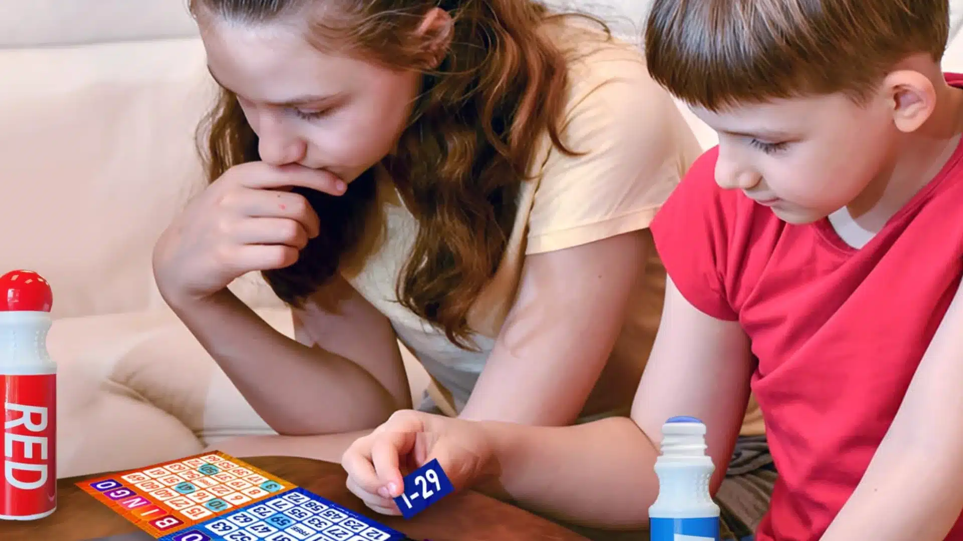 Children playing bingo game at home, focusing on numbers while enjoying fun and learning activity together