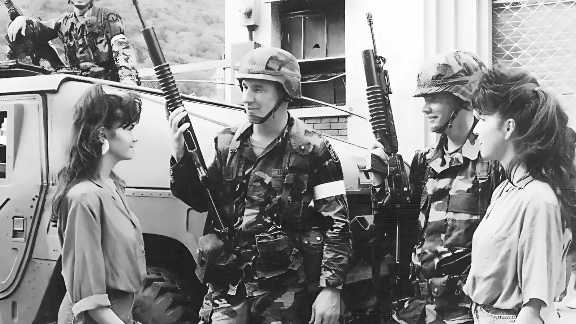Vintage image of armed soldiers talking to women beside military vehicle during tense roadside interaction