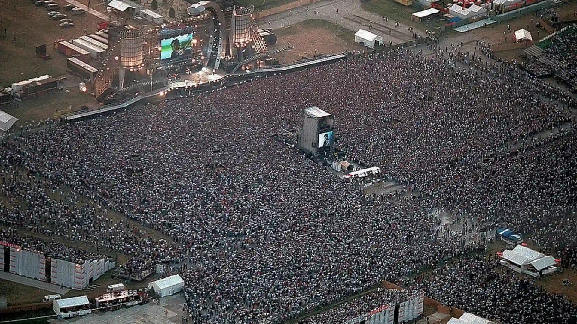 Aerial view of massive crowd gathered at Rolling Stones concert with large stage setup and packed audience