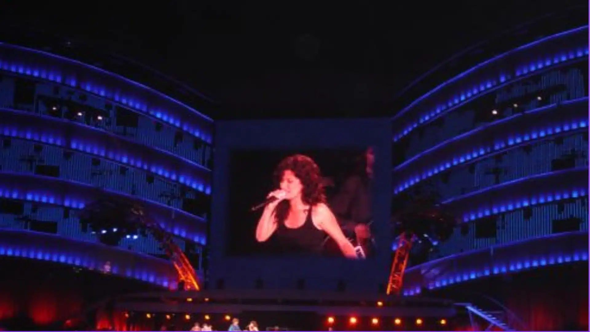 Rolling Stones performing live on stage with massive crowd and giant screen display at Lisbon concert venue