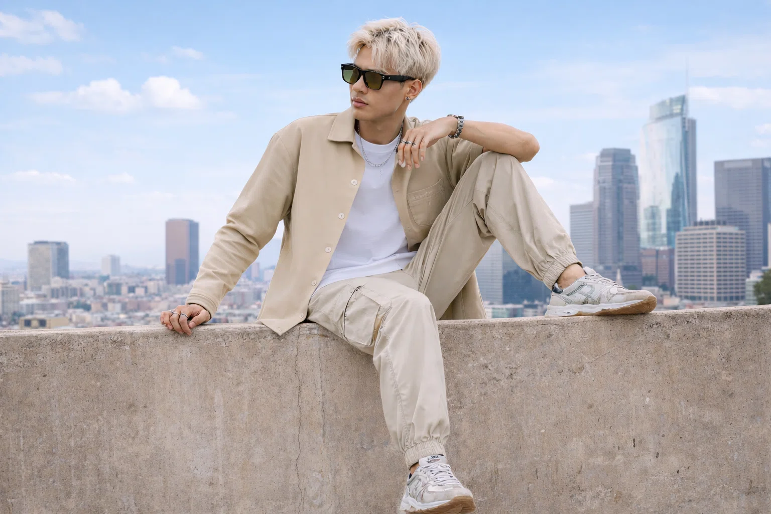 Gen Z boy in beige shacket layered over white tee with joggers and sneakers