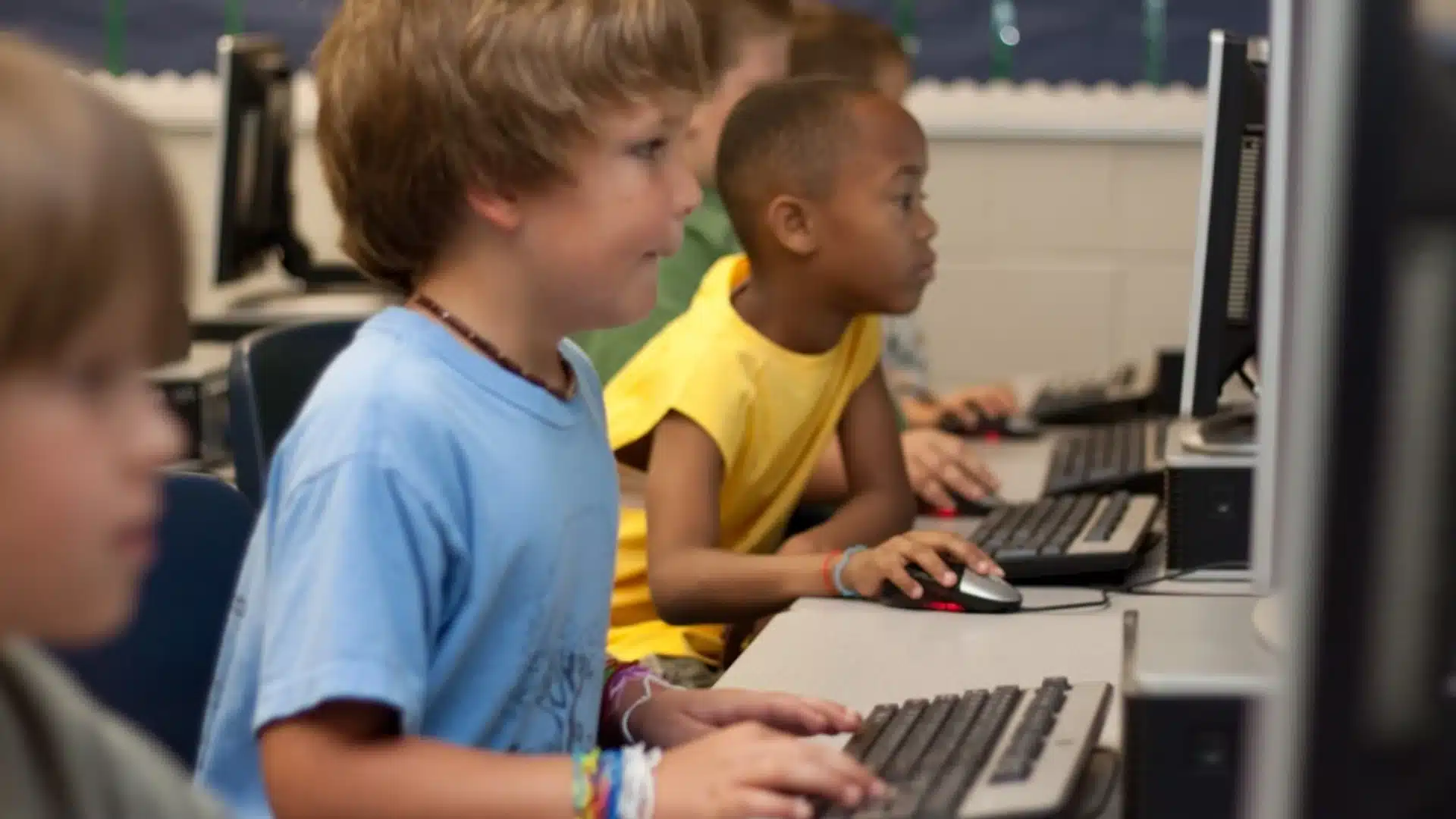 Students using computers in classroom during interactive virtual school event or activity session