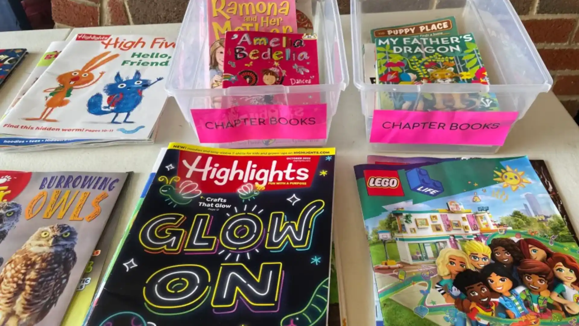 Table with children books and magazines for swap, encouraging reading and sharing among kids