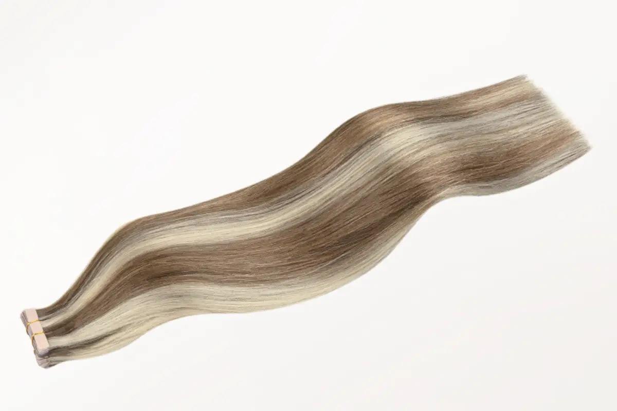 Blonde and brown hair extensions with smooth texture on white background