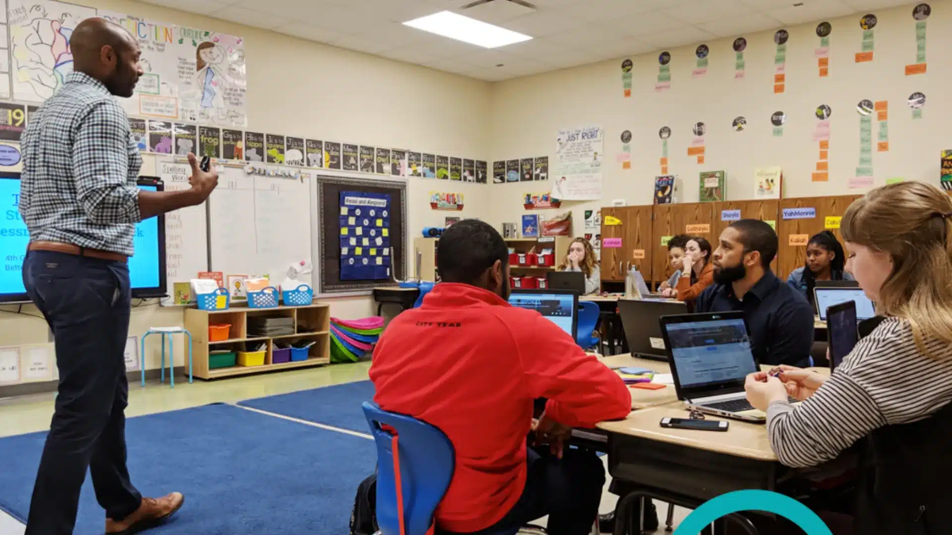 Workshop session in classroom with instructor teaching adults using laptops and interactive discussion