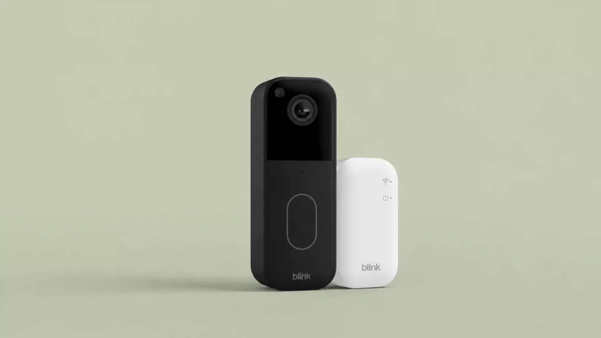 A black Blink video doorbell stands next to a smaller, white Blink Sync Module against a light olive background