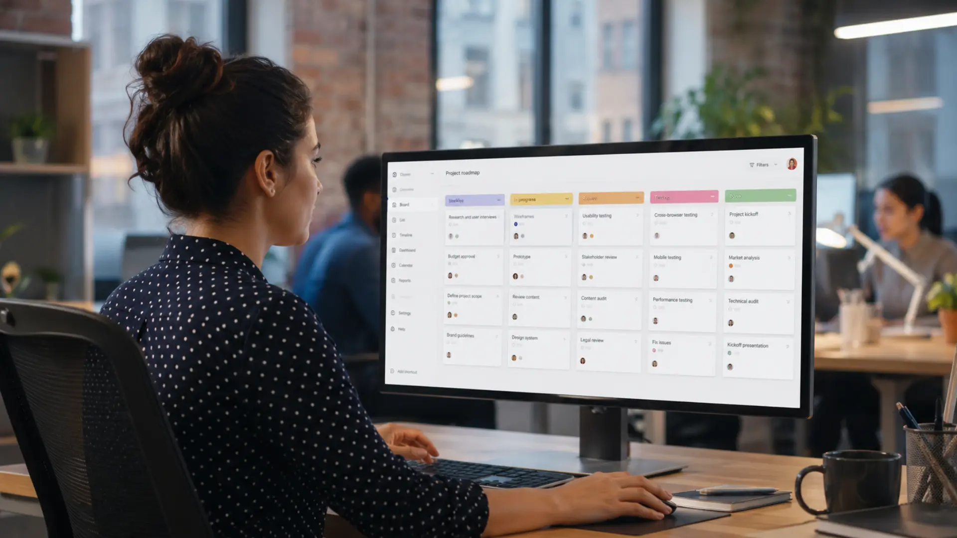 Professional using Trello project management board on desktop monitor in modern office