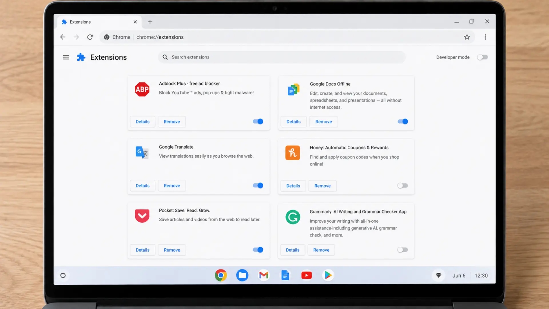 Chromebook screen showing Chrome extensions page with app cards and toggles