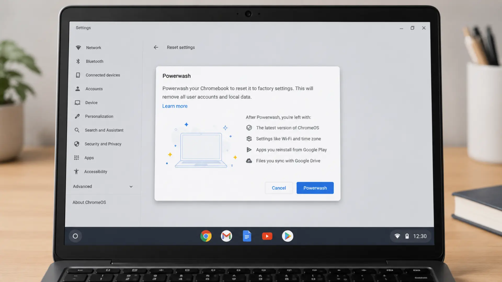 Chromebook screen showing Powerwash reset dialog on a minimalist desk