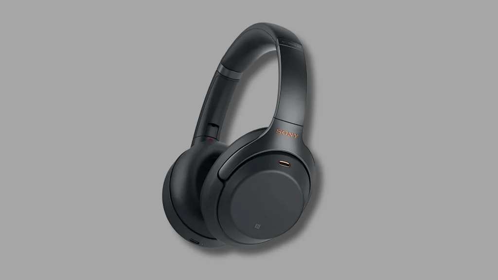Close up of Sony wireless headphones on plain gray background, minimal product view