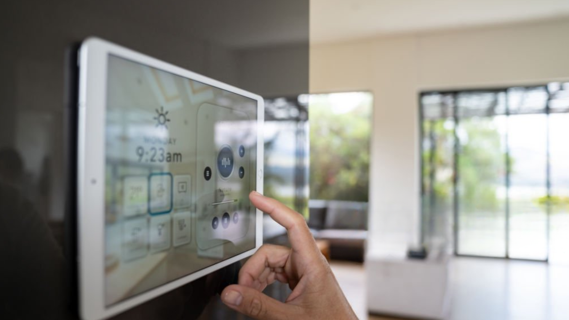 Close-up on a person using a home automation system to control the music - smart homes concepts.