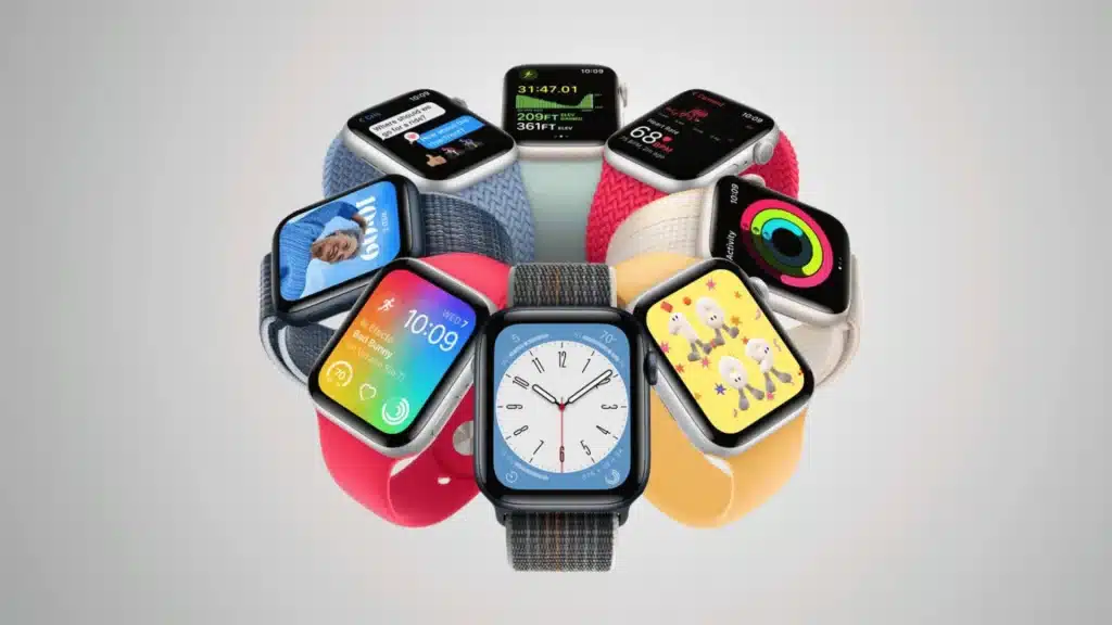 Collection of colorful Apple Watch models with different bands and watch faces displayed in a circular arrangement on a gray background