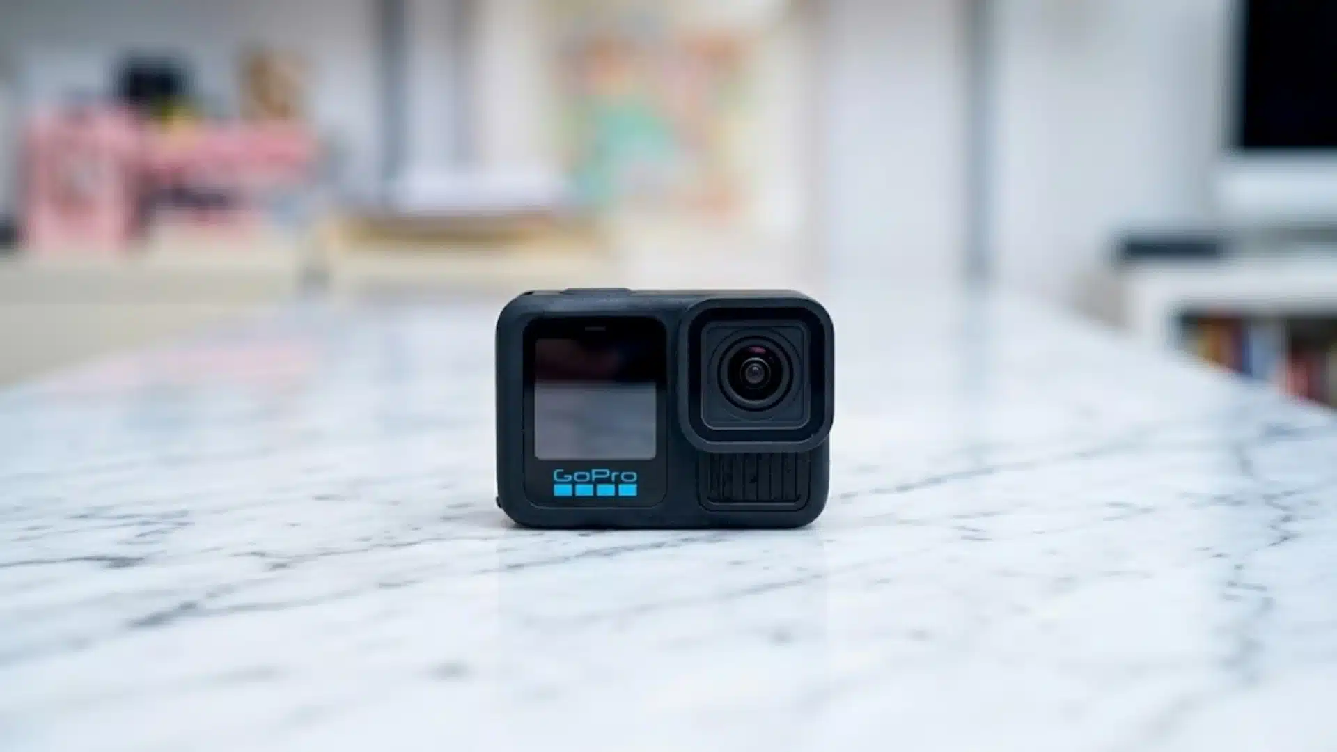 GoPro HERO13 Black action camera placed on a marble table with a blurred indoor background