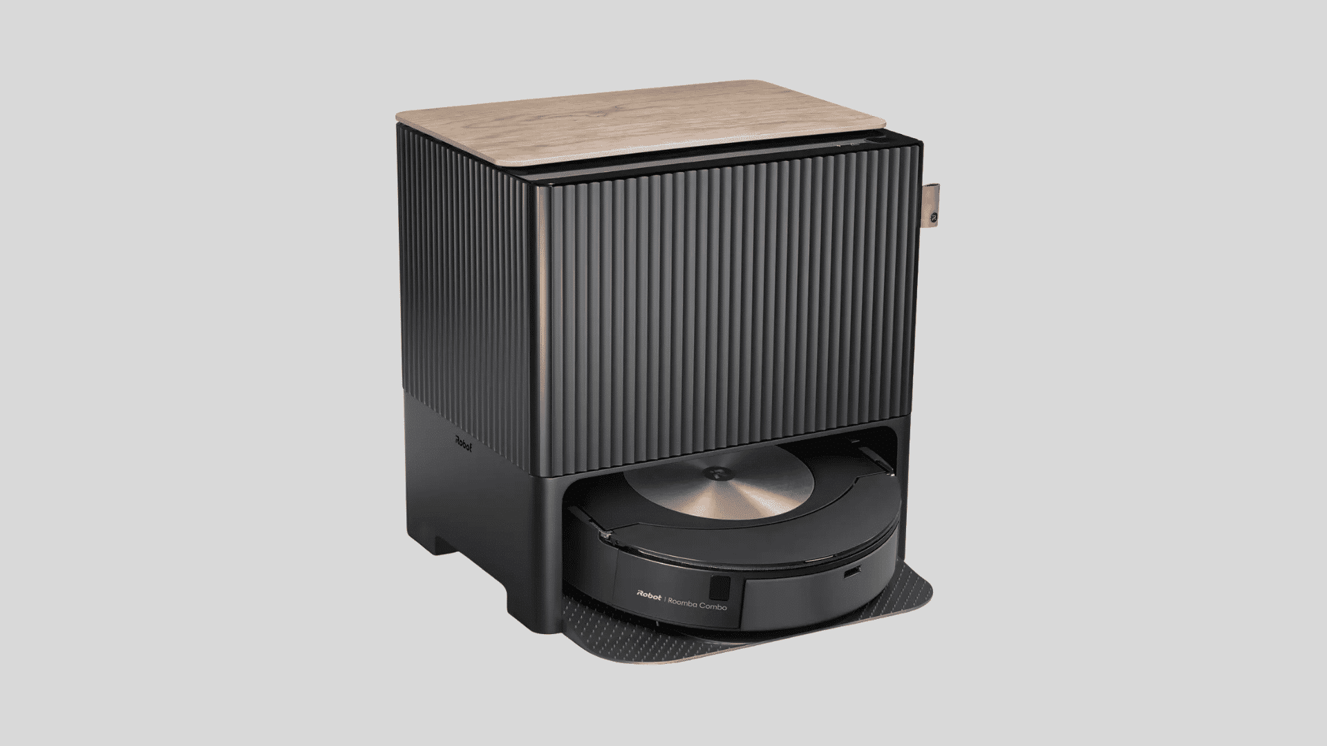 iRobot Roomba Combo robot vacuum under a black docking station with wood top, showing a modern compact design