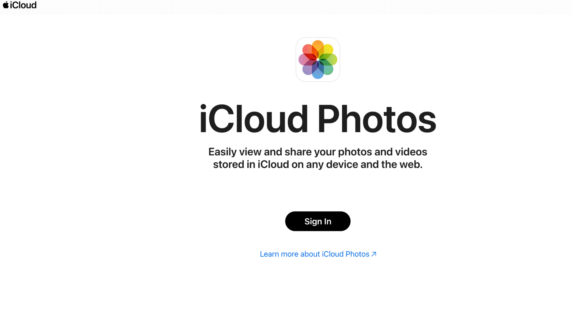 icloud photos sign in page with apple logo centered text and learn more link on a clean white background