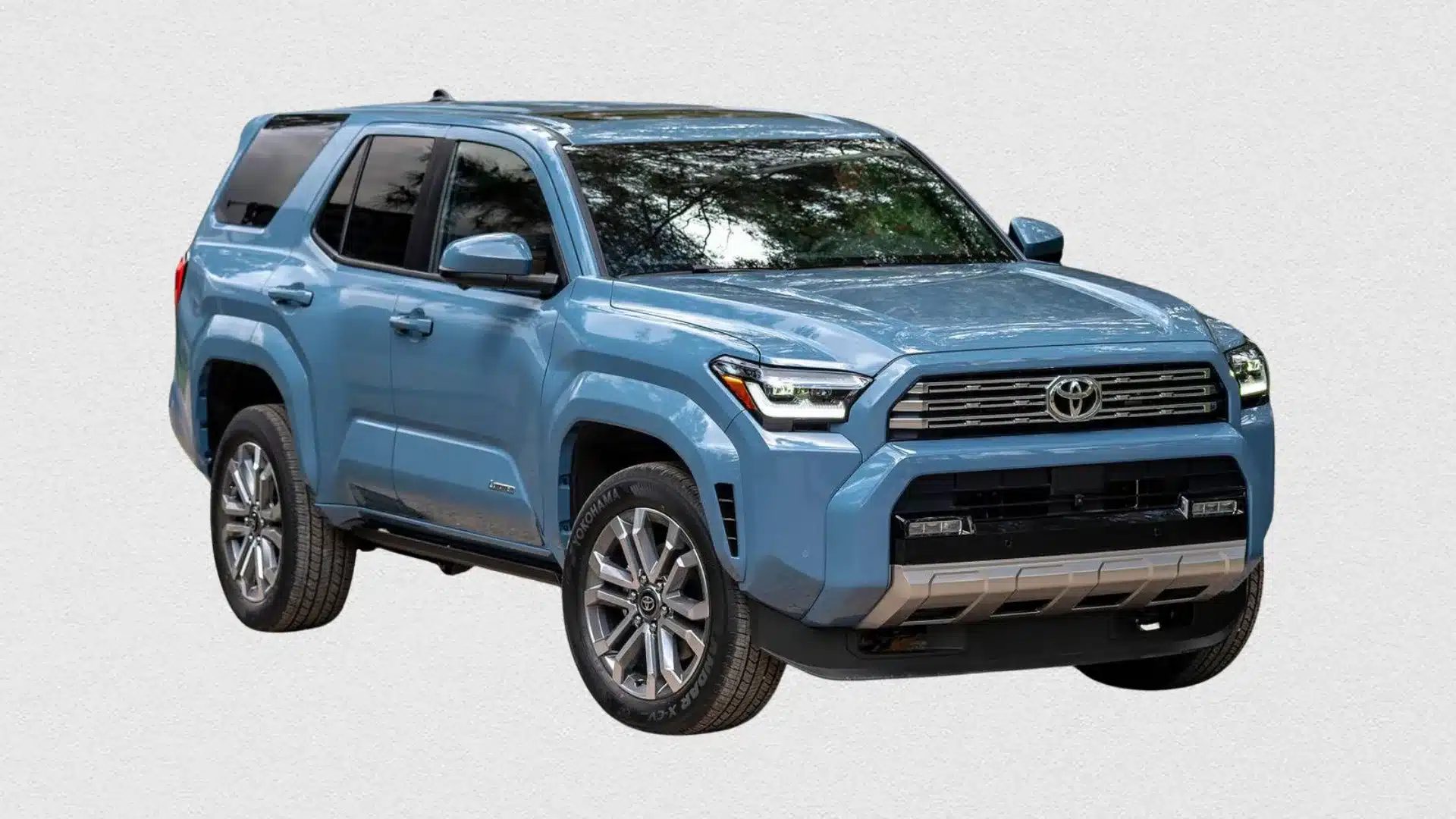 Light blue Toyota 4Runner SUV parked at an angle with black roof, tinted windows, and silver front skid plate on a plain white background