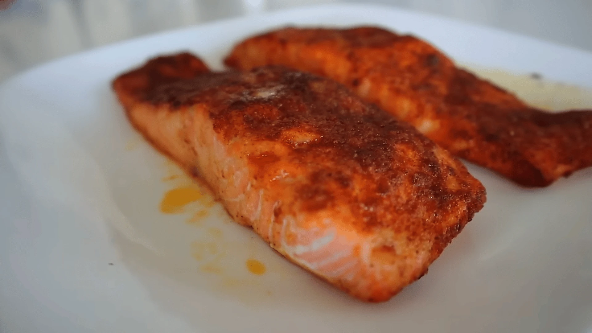 Prepping salmon fillets with seasoning before putting in air fryer