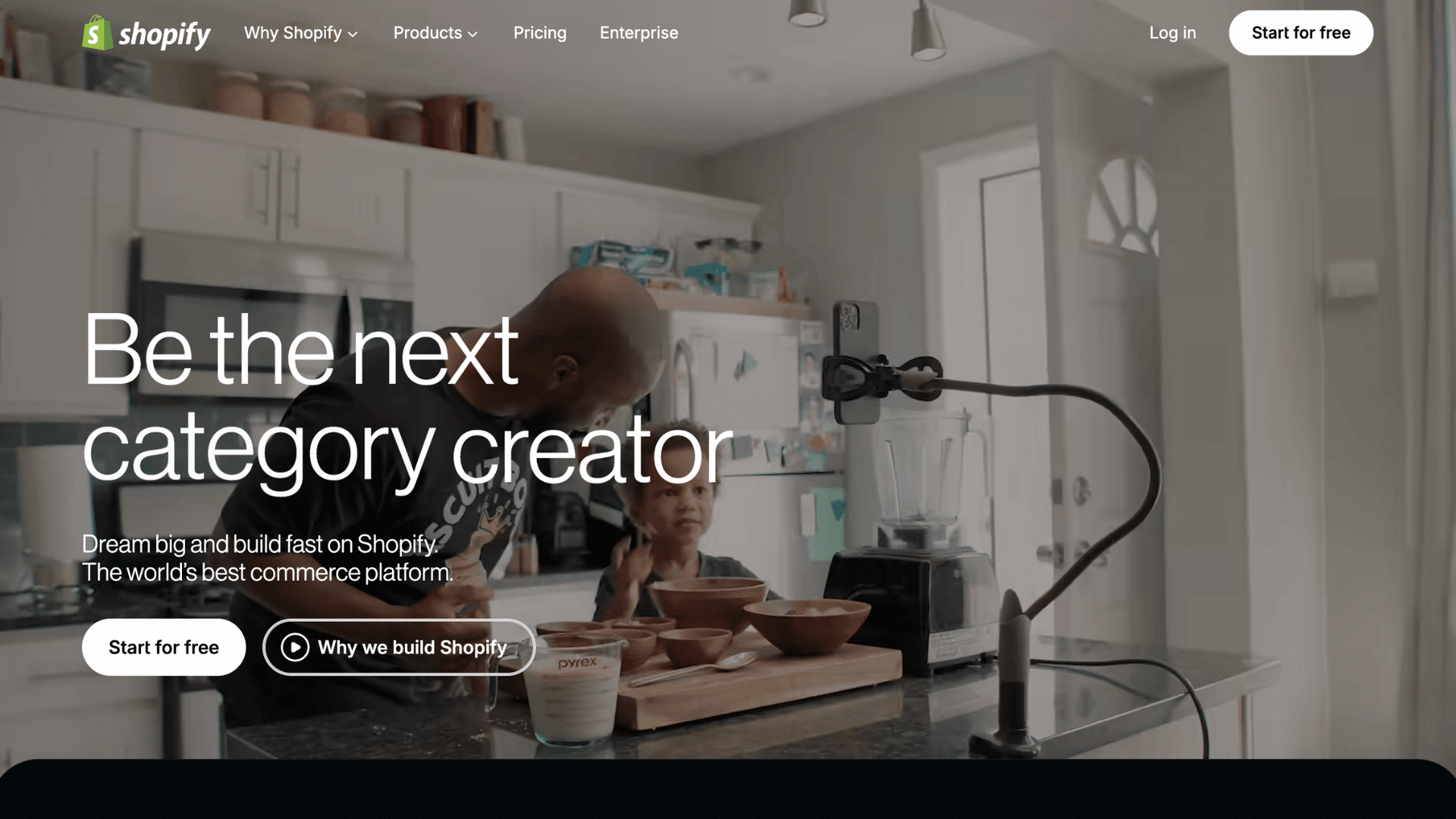 shopify homepage with family cooking scene and be the next category creator message beside start free button