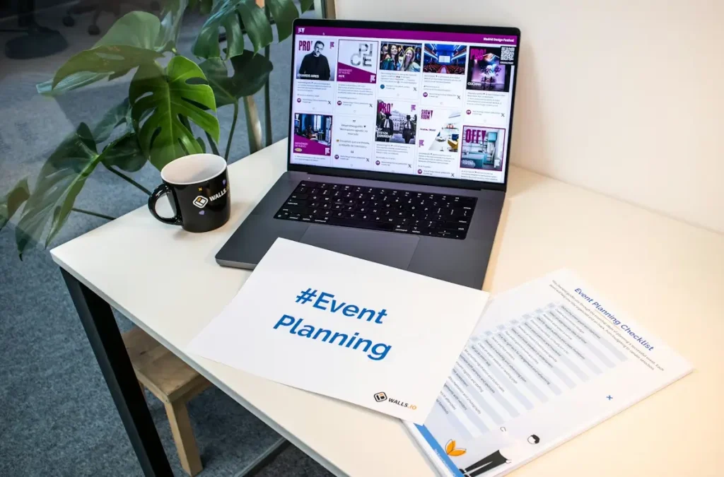 Laptop displaying event listings on desk with event planning documents and coffee mug