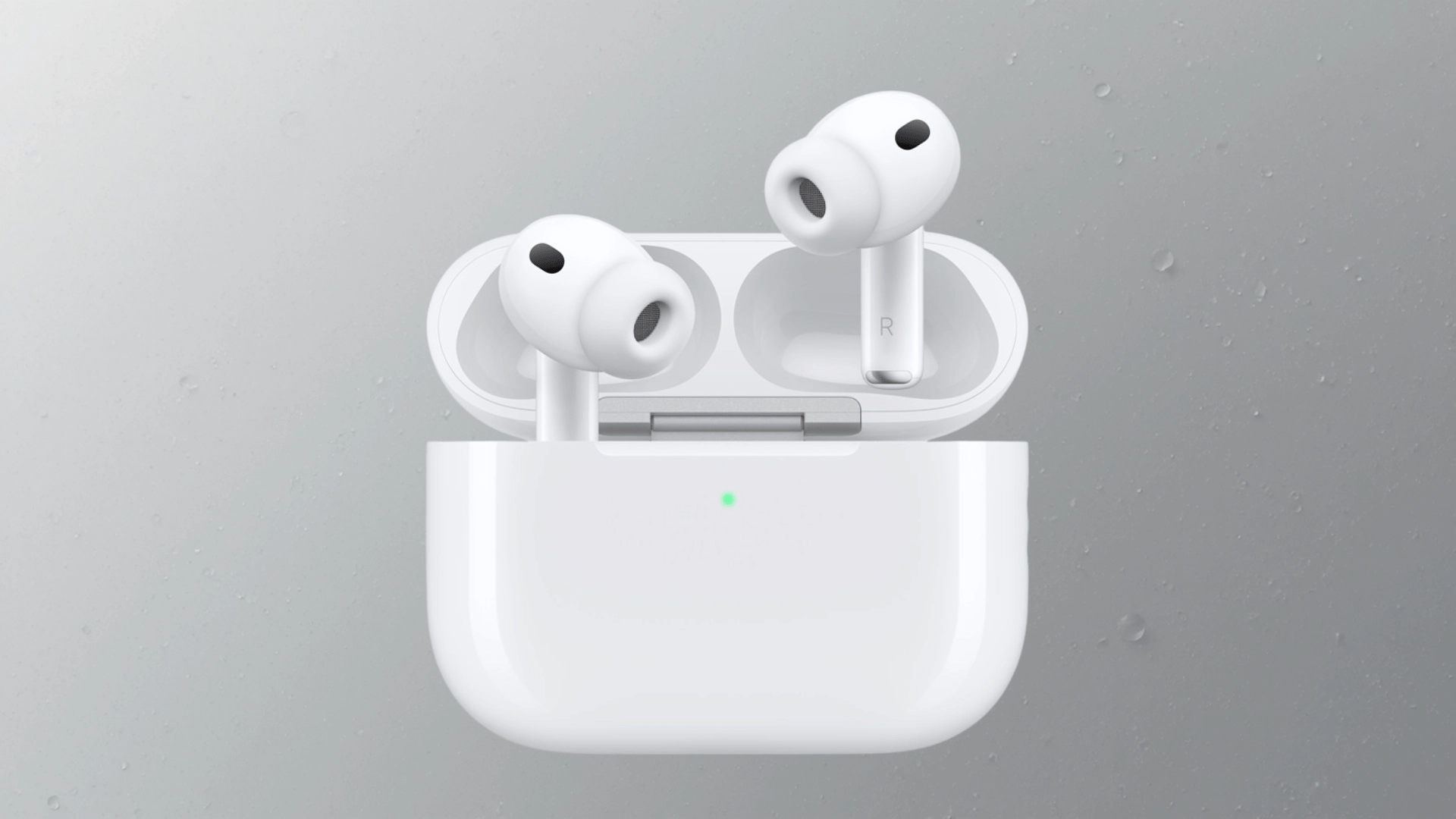 White wireless earbuds in charging case with silicone tips and LED indicator on gray background