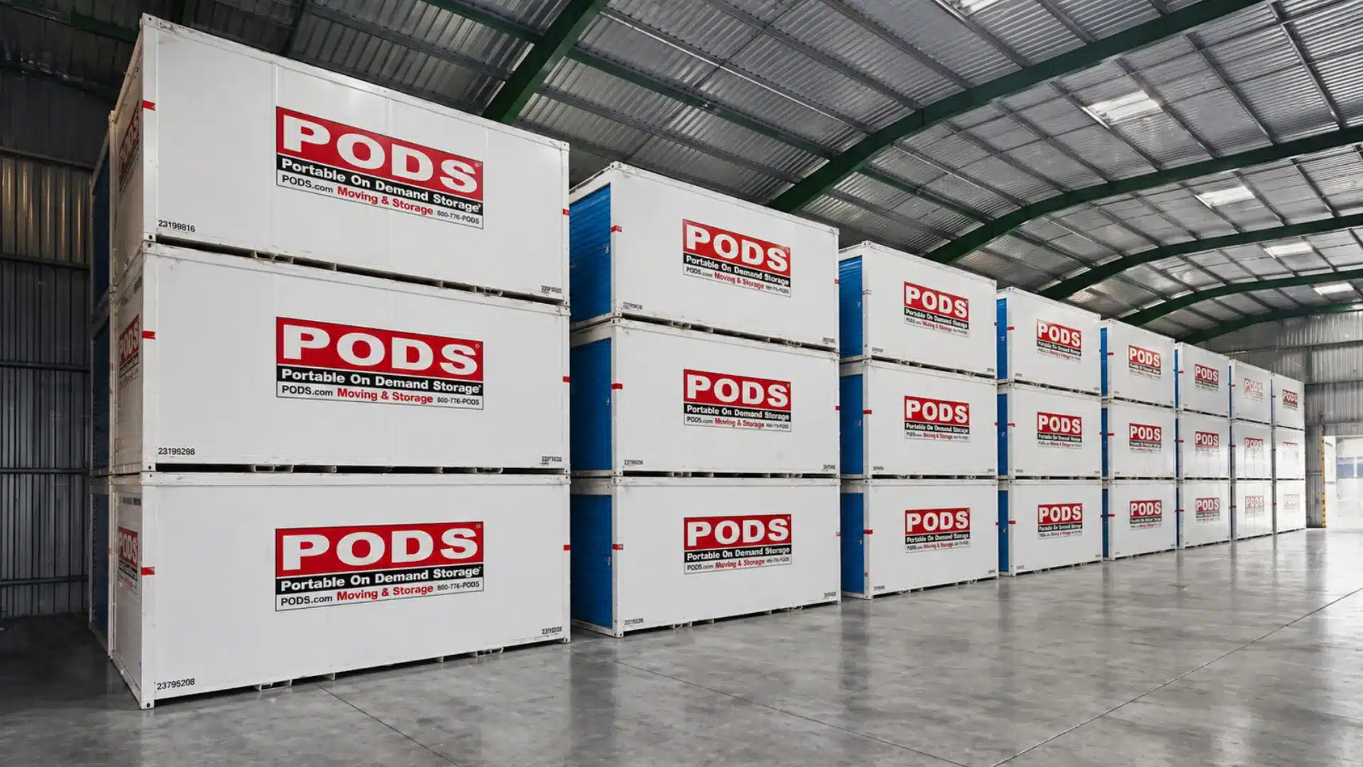 Wide angle view of PODS storage containers stacked inside a large warehouse with clean polished flooring