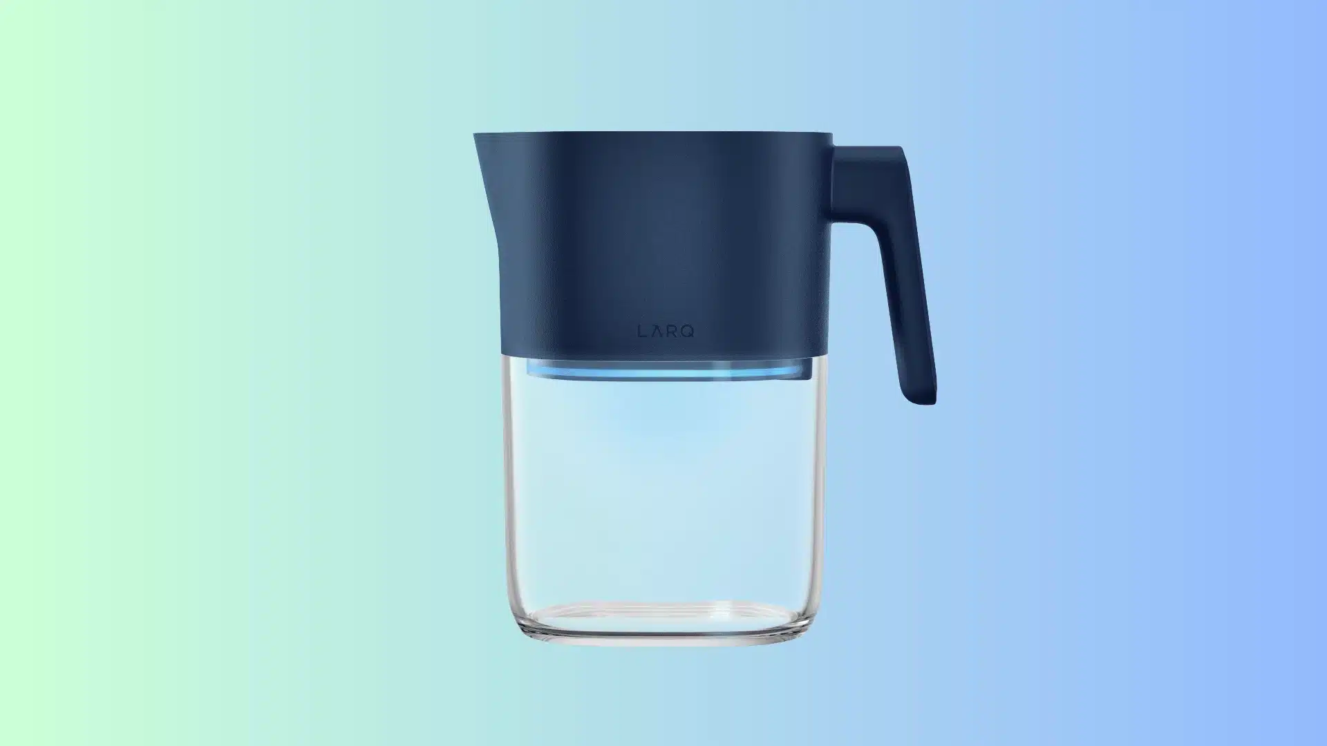 A LARQ water filter pitcher with a dark blue upper body, lid, and handle, sitting on a clear glass reservoir that glows with a soft blue light