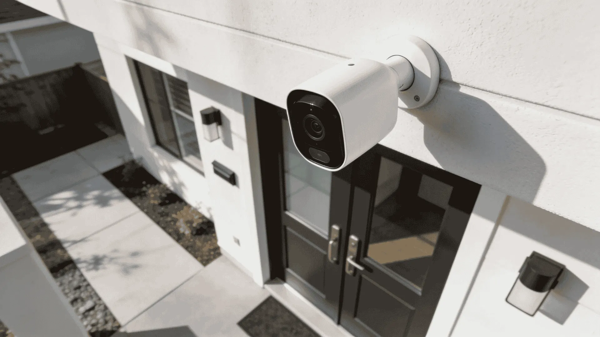 Arlo Pro 2 camera mounted above an exterior door to monitor a modern home entrance area