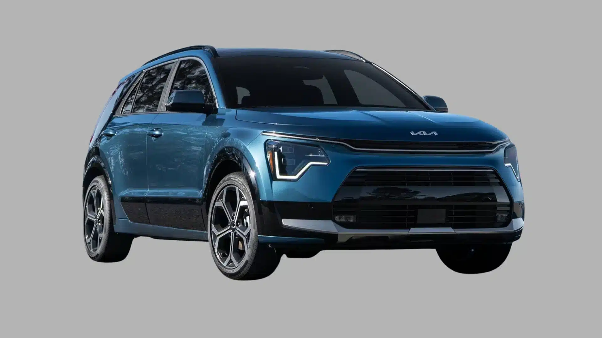 Blue Kia Niro crossover SUV shown in angled front view with LED lighting on a plain gray background