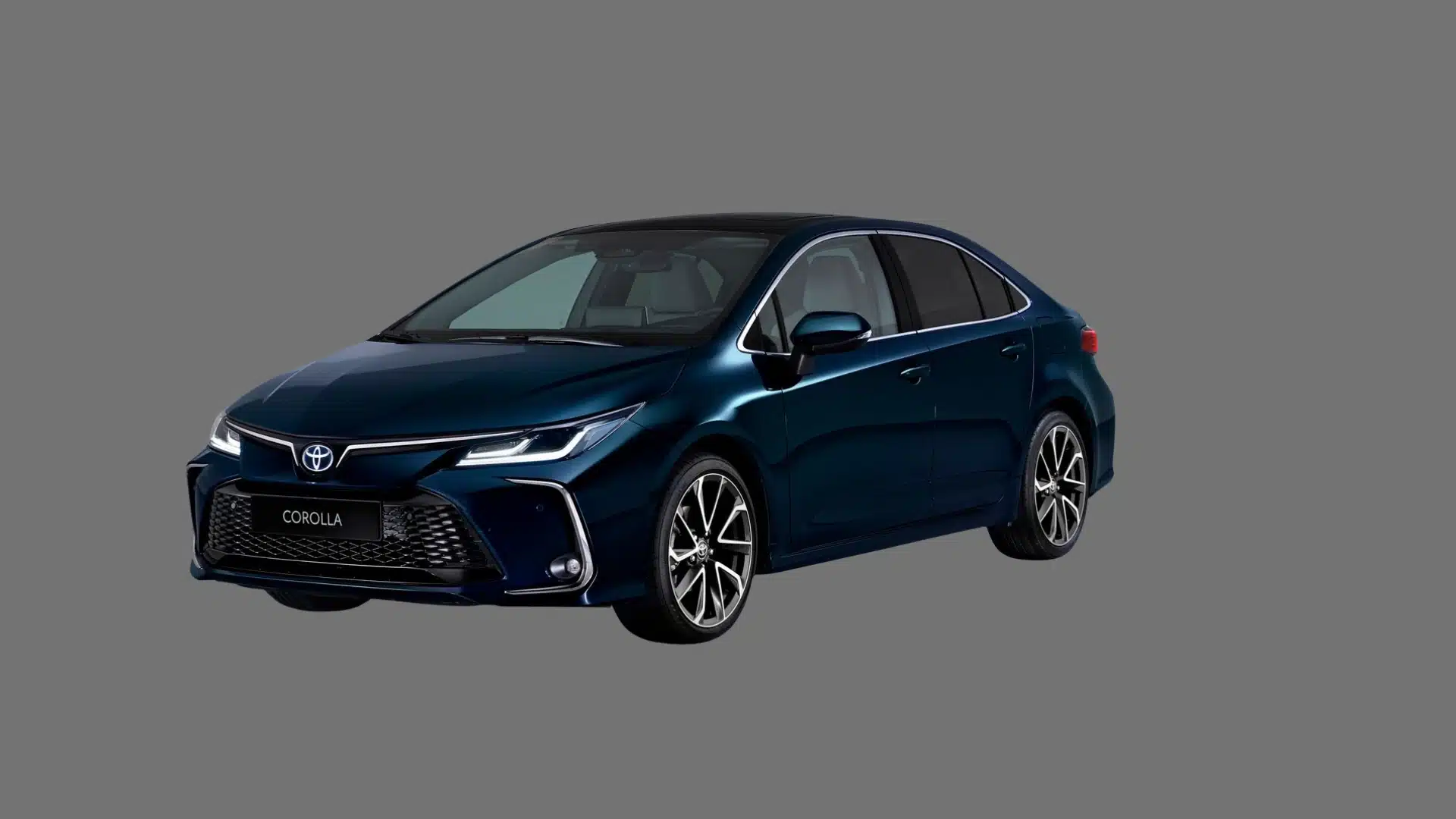 Dark blue Toyota Corolla sedan shown in angled front view with sporty grille on a plain gray background