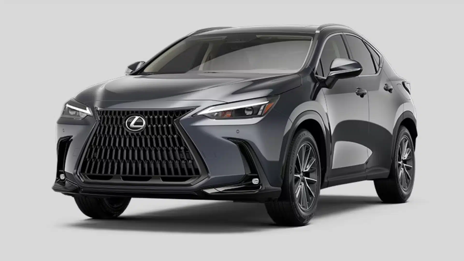 Gray Lexus NX hybrid SUV with a large front grille and modern luxury crossover styling on gray background