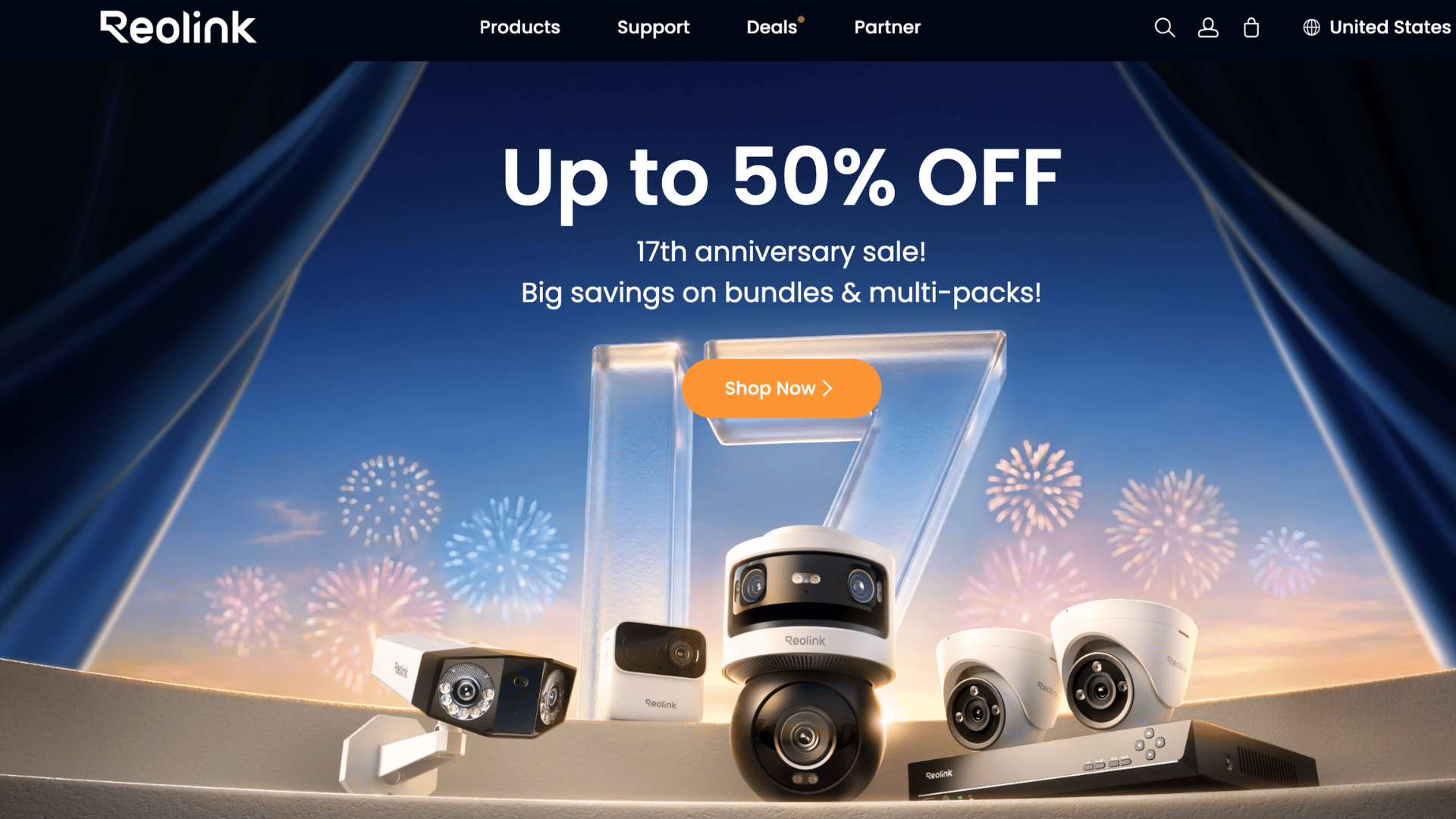 reolink website banner showing security cameras and fireworks for an anniversary sale on a blue stage background