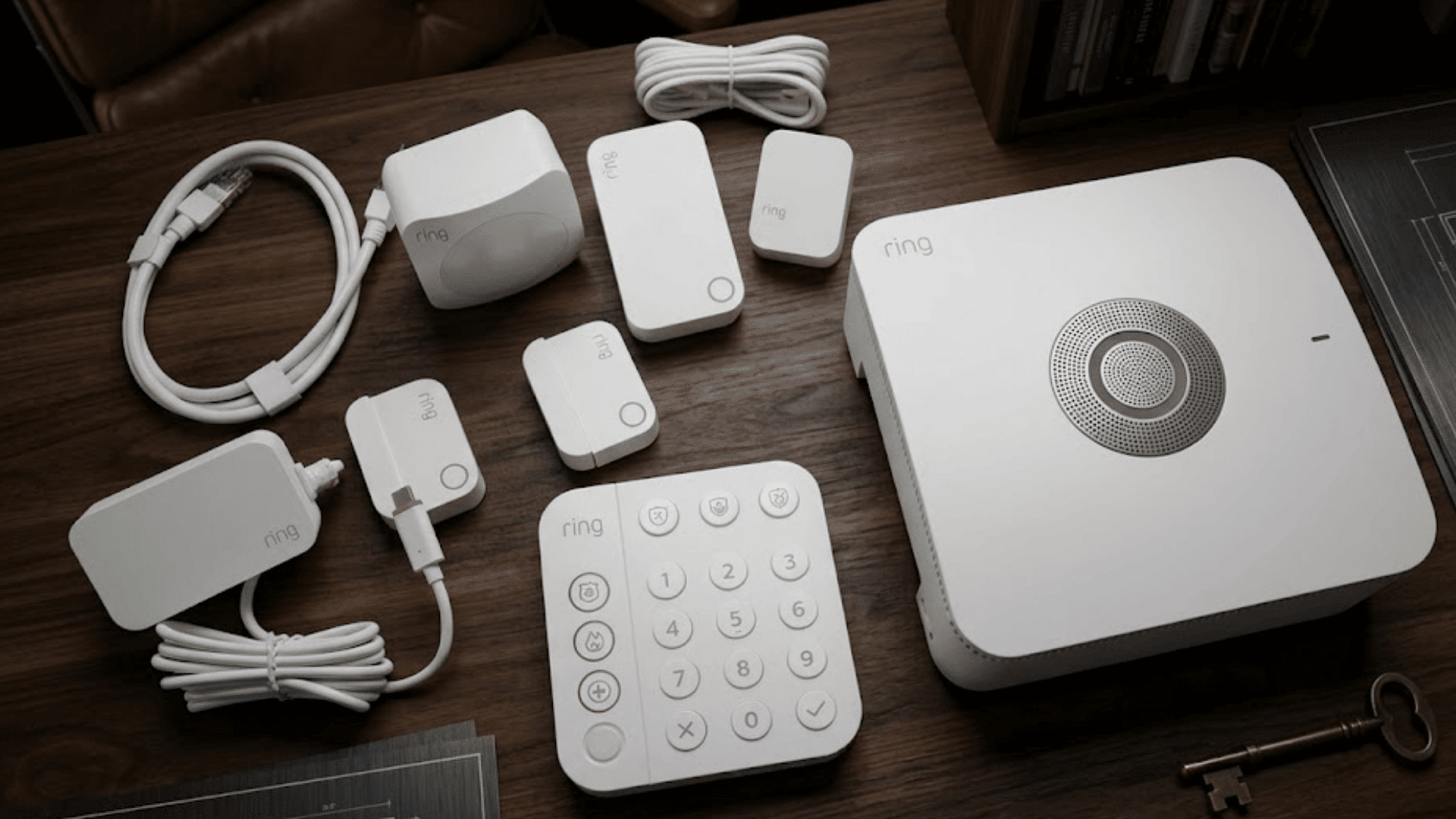 ring alarm security system kit with base station keypad sensors cables and power adapter on table
